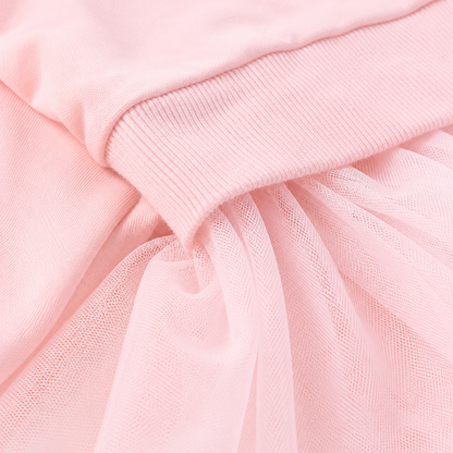Close-up of the cotton fabric and tulle texture on a pink girls dress.