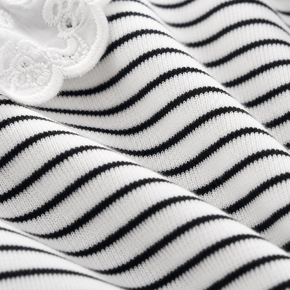 Close-up of the black and white striped fabric texture on a girls long sleeve top.