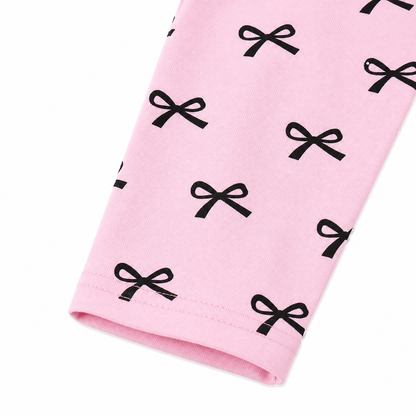 Close-up of the black bow print detail on the pink pants.