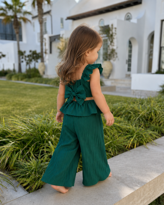 Girl wearing the Lilia Bow Set outdoors