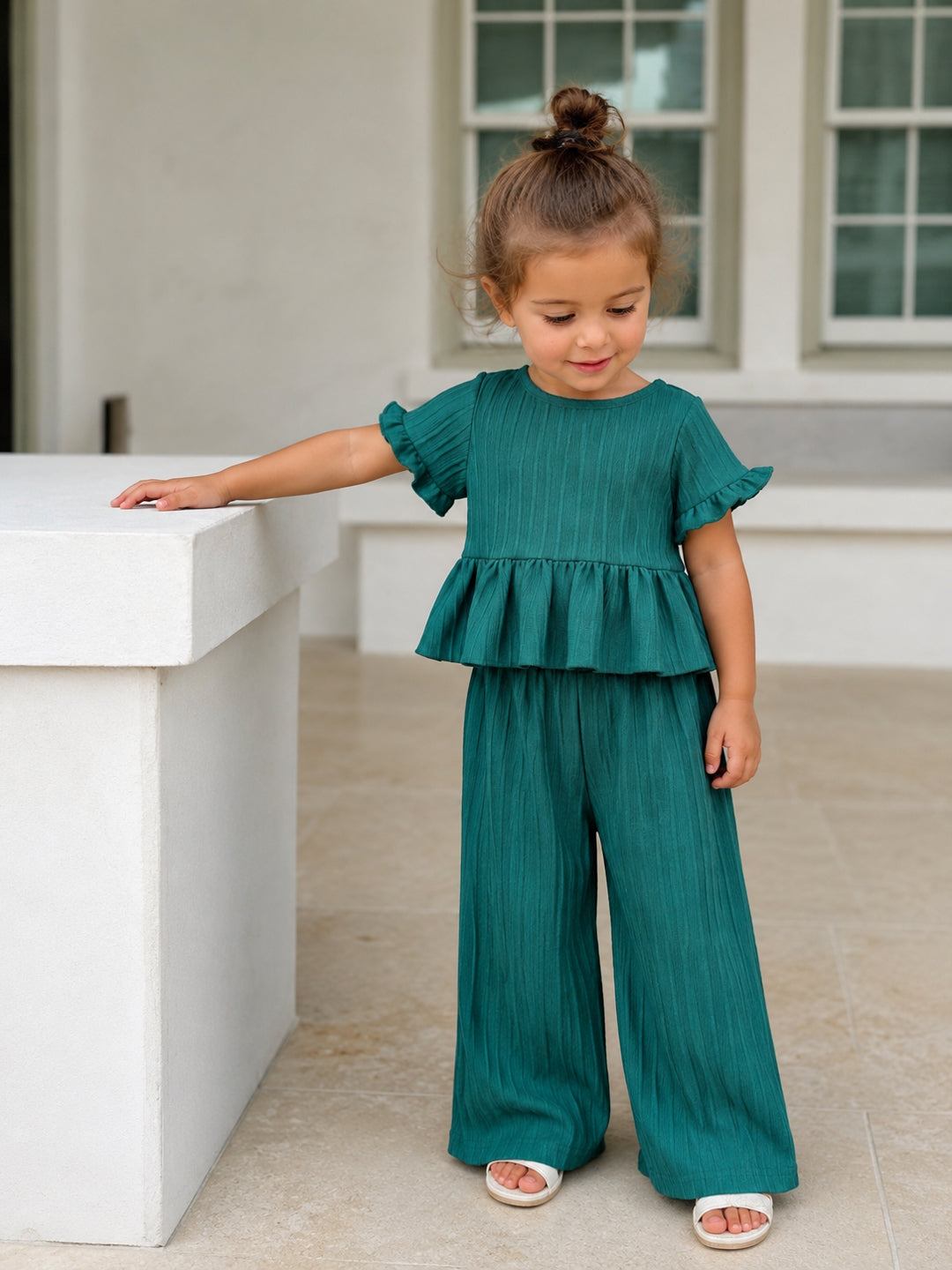 Girl wearing the Meadow Ruffle Set outdoors