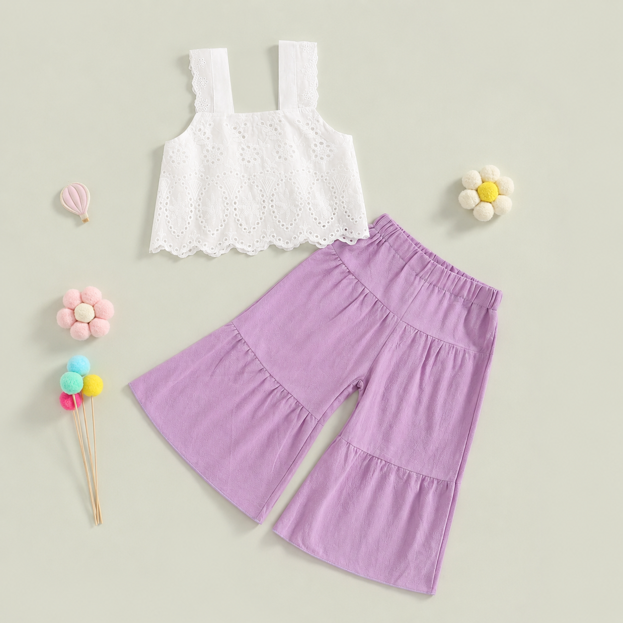 Close up of white eyelet fabric on girls summer set