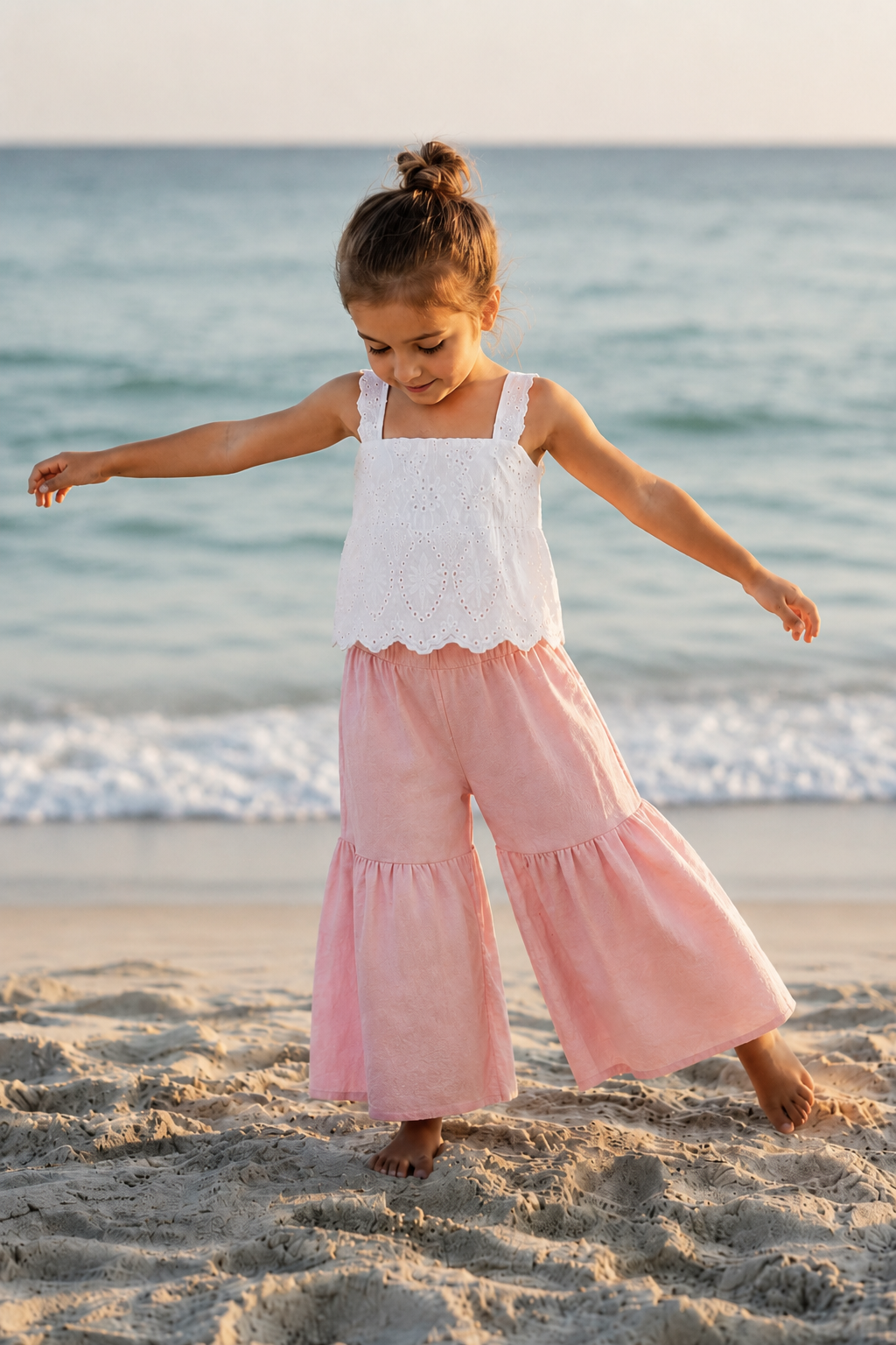 Girl wearing the Sunday Eyelet Set by the beach