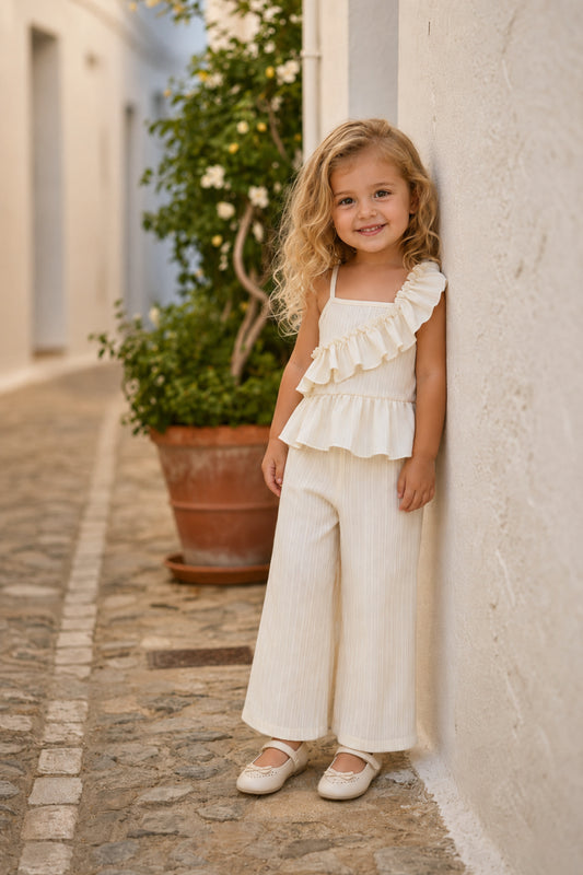 Girl wearing the Luna Ruffle Set outdoors