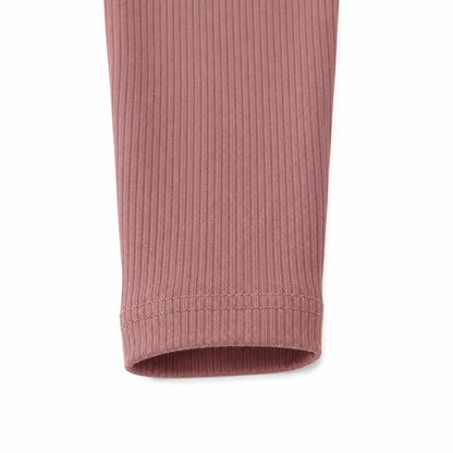 Close-up of the ribbed mauve leggings hem detail.