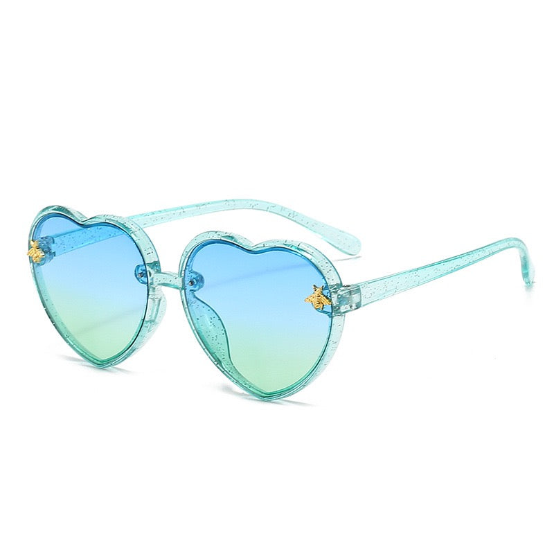 Blue green gradient kids sunglasses with heart frame design for beach and vacation outfits.