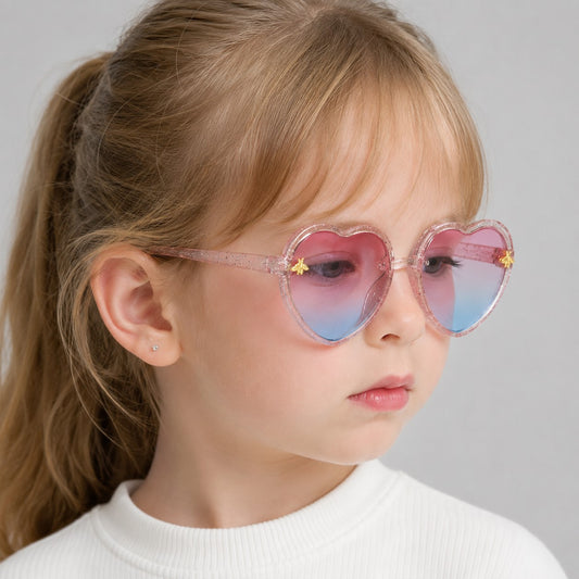 Girl wearing heart shaped kids sunglasses with UV400 lenses for a cute summer look.