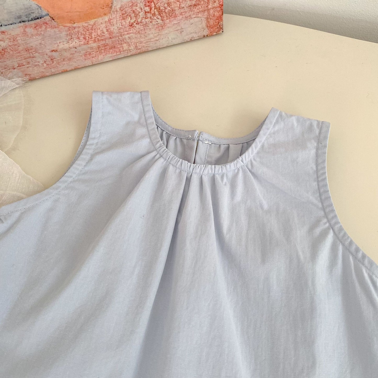 Close-up of the Bluebell Lace Set light blue sleeveless top neckline and soft gathered fabric.