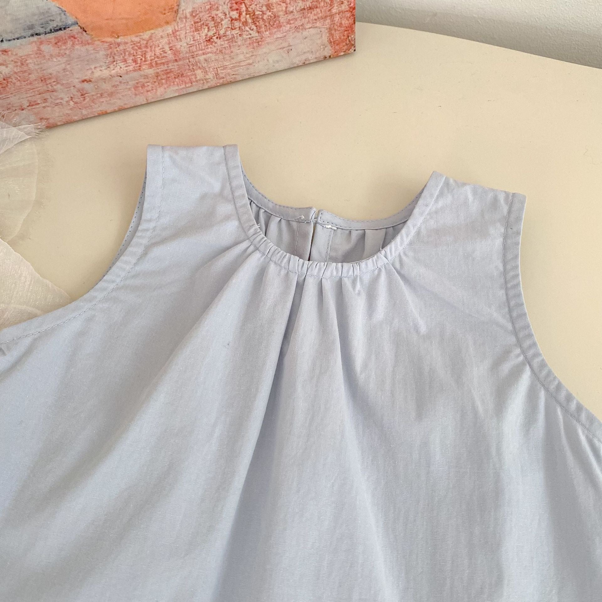 Close-up of the Bluebell Lace Set light blue sleeveless top neckline and soft gathered fabric.