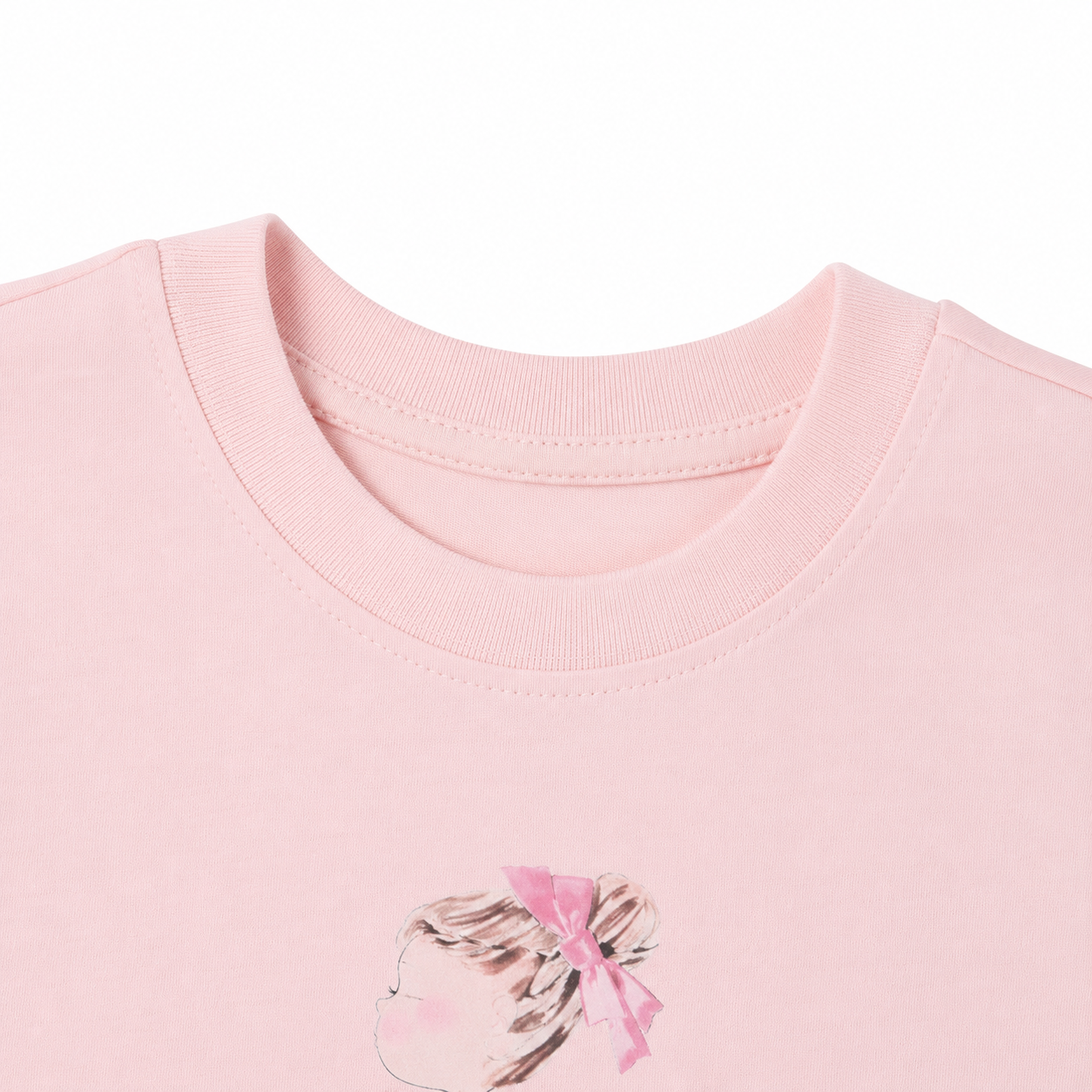 Close-up of the crew neckline and girl illustration on the blush pink T-shirt.