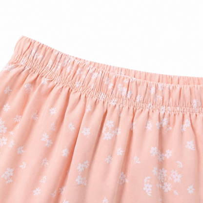 Close-up of the elastic waistband and small floral print on the blush pink shorts.