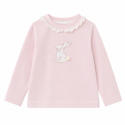 Front flat lay of the Blush Pink girls cotton long sleeve top with ruffle collar and bunny embroidery with a small pom-pom tail detail on a white background.
