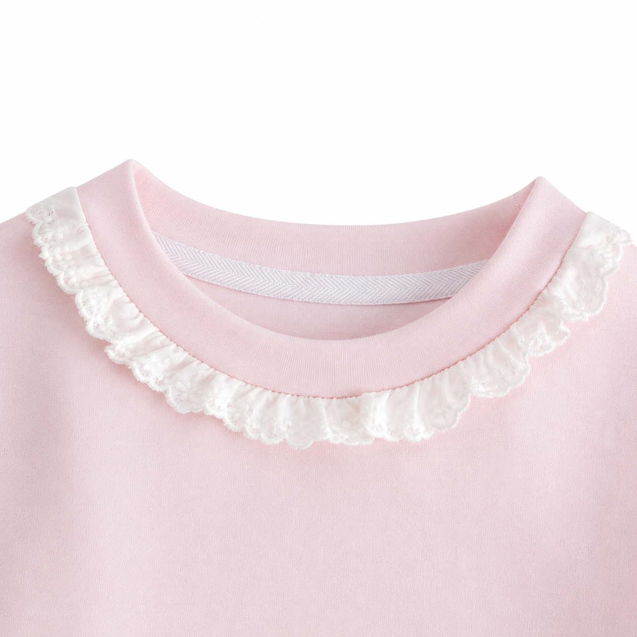 Close-up of the ruffle-trim crew neckline on the Blush Pink girls cotton long sleeve top.