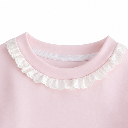 Close-up of the ruffle-trim crew neckline on the Blush Pink girls cotton long sleeve top.