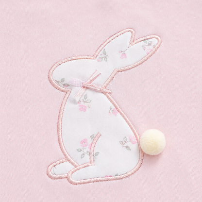 Close-up of the bunny embroidery with a small pom-pom tail detail on the Blush Pink girls cotton long sleeve top.