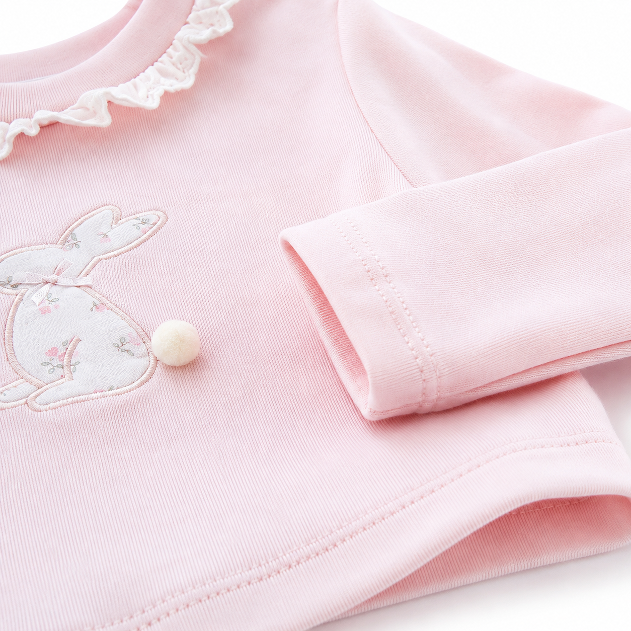 Close-up of the cotton fabric and construction detail on the Blush Pink girls long sleeve top.