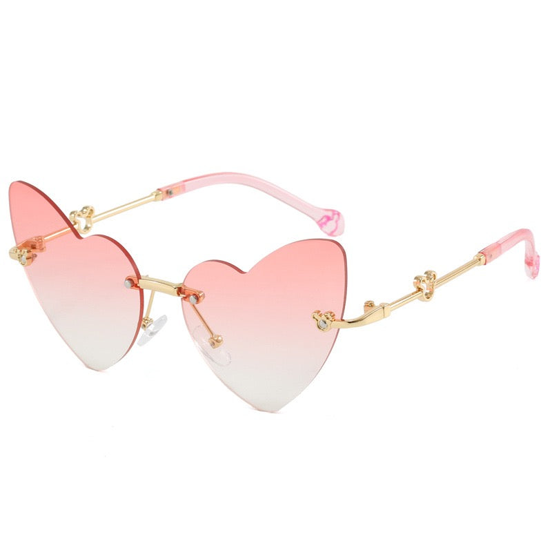 Soft pink kids heart sunglasses with rimless heart shaped lenses