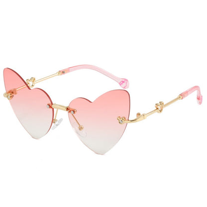 Soft pink kids heart sunglasses with rimless heart shaped lenses