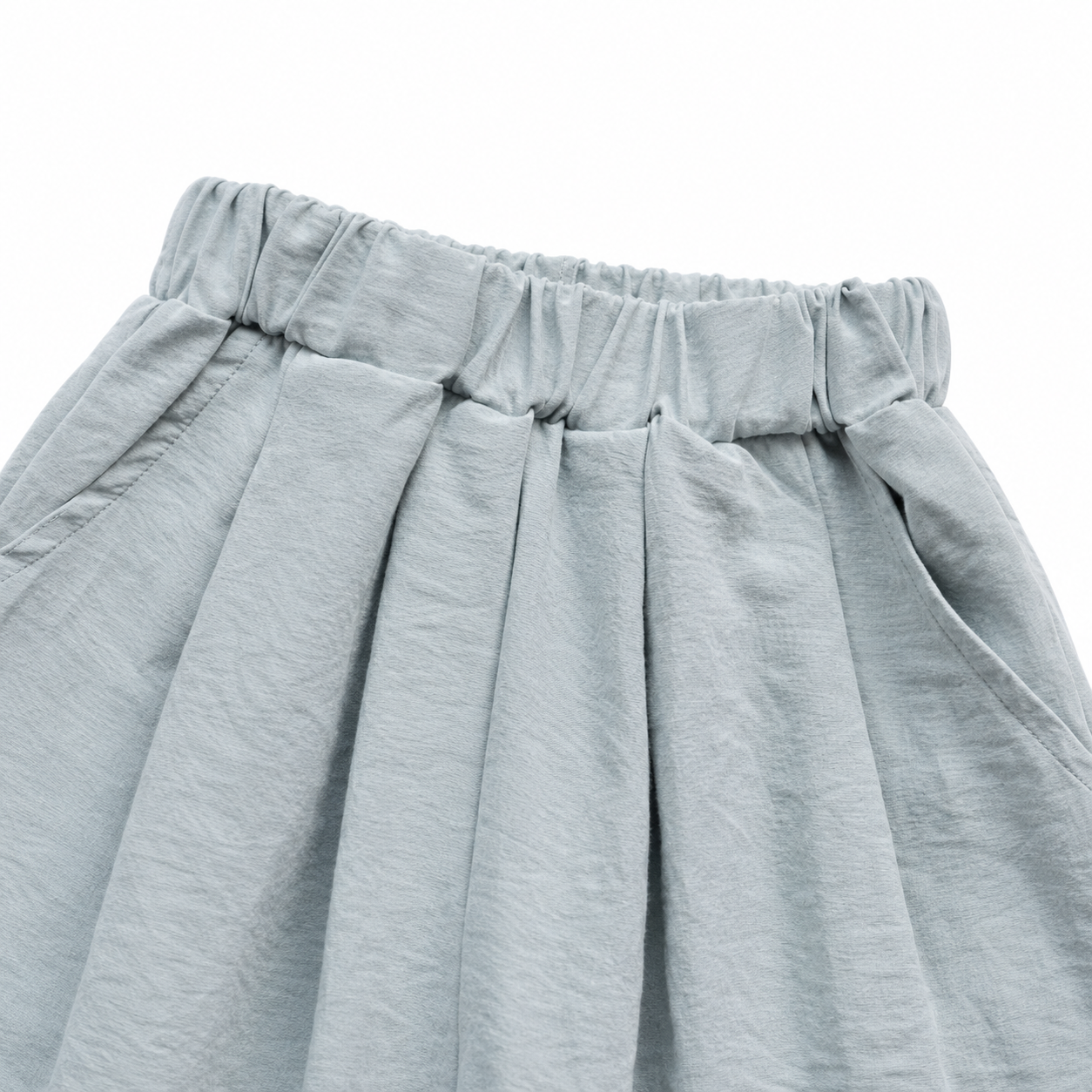 Close-up of the elastic waist construction on the dusty blue girls pants.