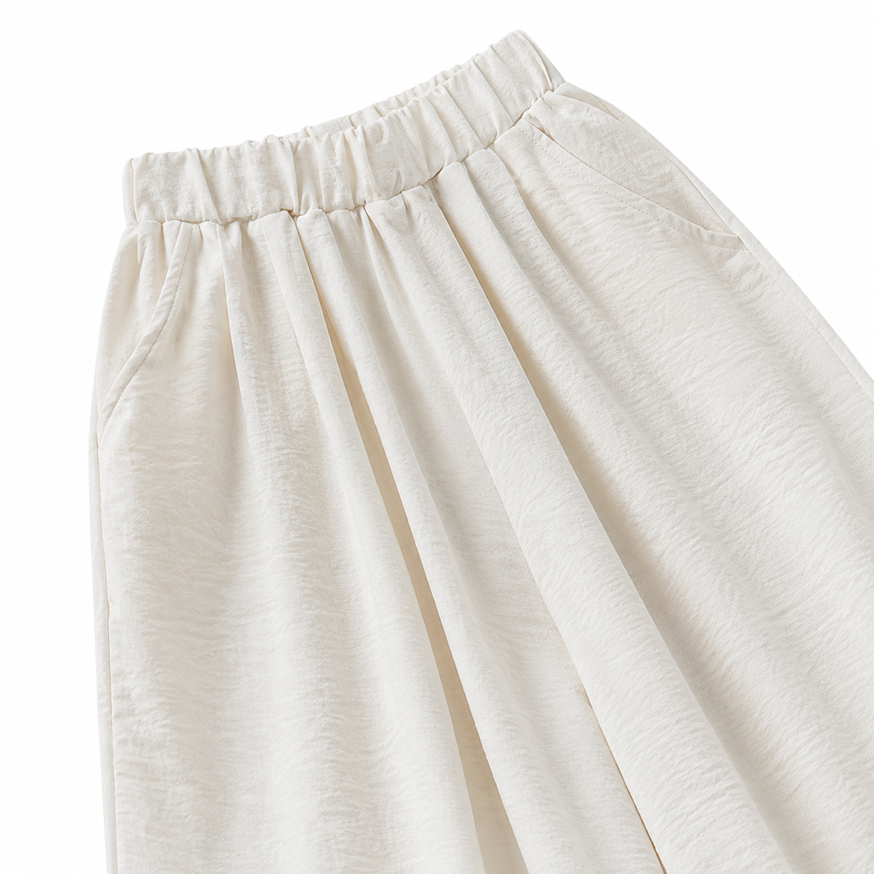 Close-up of the side pocket and wide-leg shape on the ivory pants.