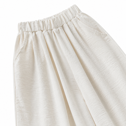 Close-up of the side pocket and wide-leg shape on the ivory pants.