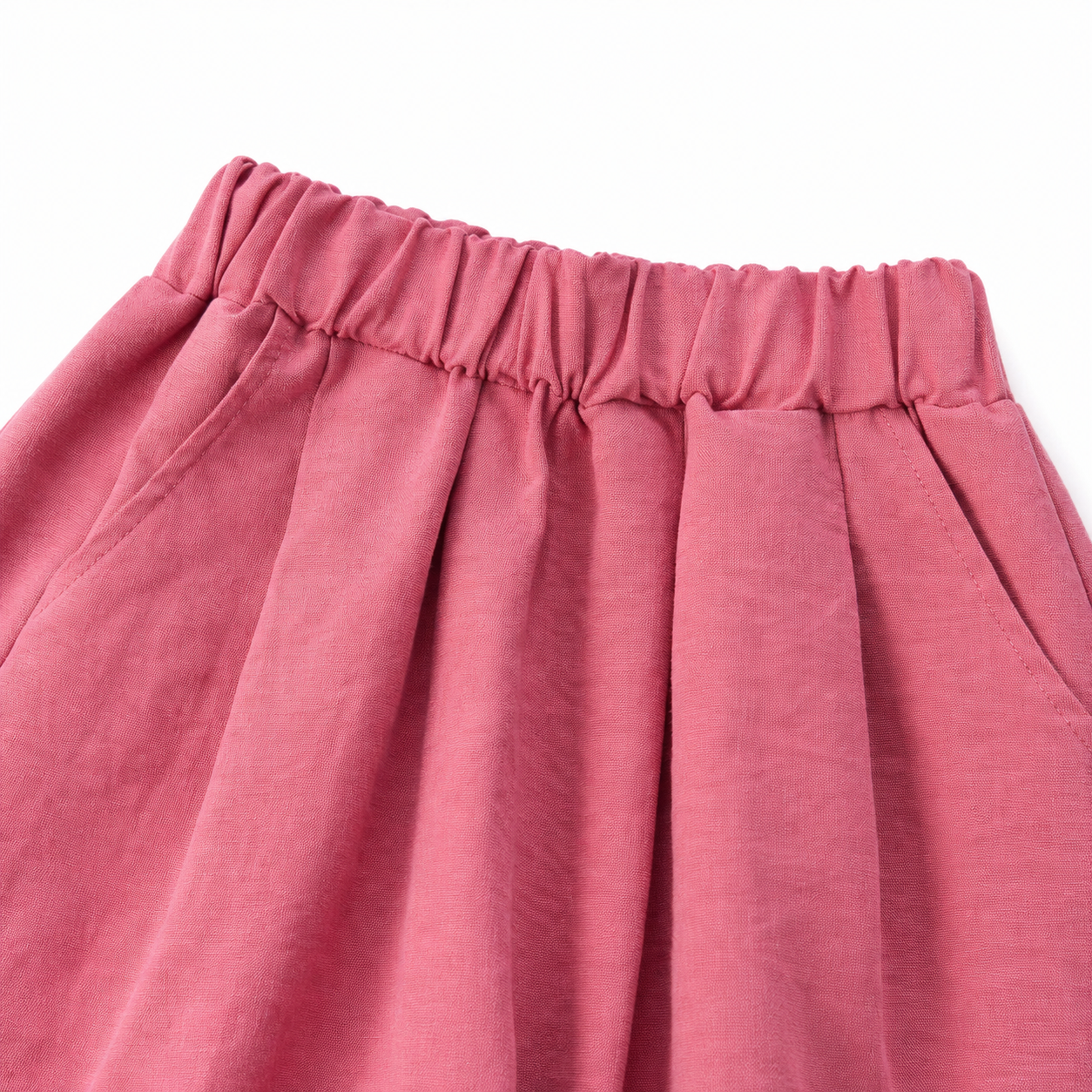 Close-up of the pleated elastic waistband on the rose pink culotte pants.