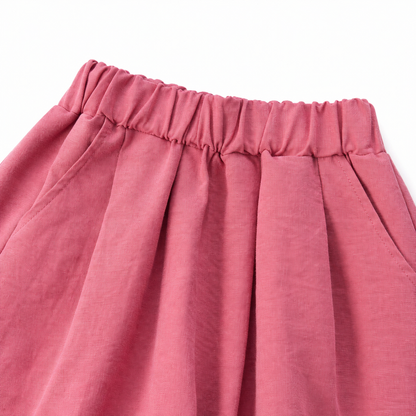 Close-up of the pleated elastic waistband on the rose pink culotte pants.