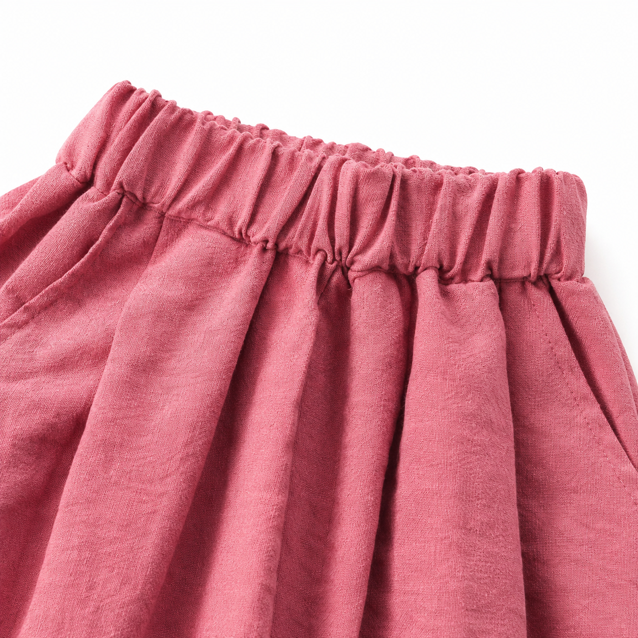 Close-up of the elastic waist construction on the rose pink girls pants.