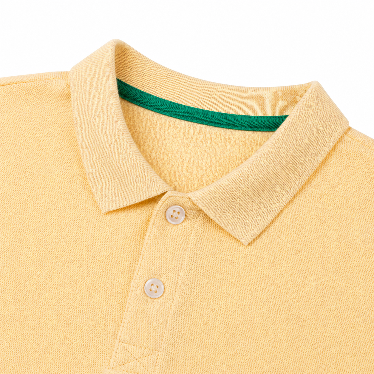 Close-up of the polo collar and two-button placket on the butter yellow kids shirt.