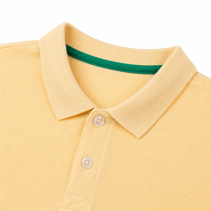 Close-up of the polo collar and two-button placket on the butter yellow kids shirt.