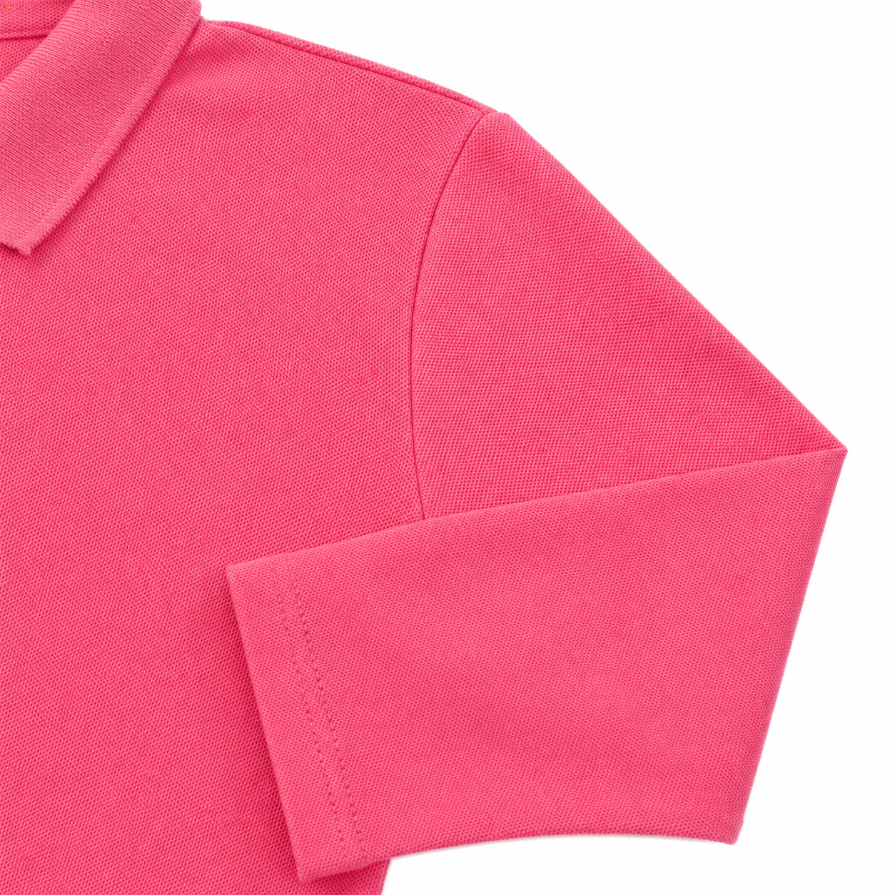 Close-up of the long sleeve and cotton-blend fabric on the hot pink kids polo.