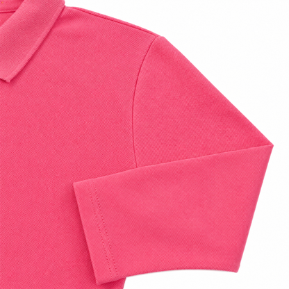 Close-up of the long sleeve and cotton-blend fabric on the hot pink kids polo.