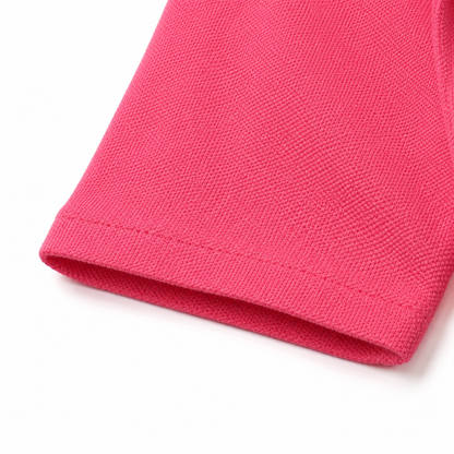 Close-up of the hem and fabric texture on the hot pink kids polo shirt.
