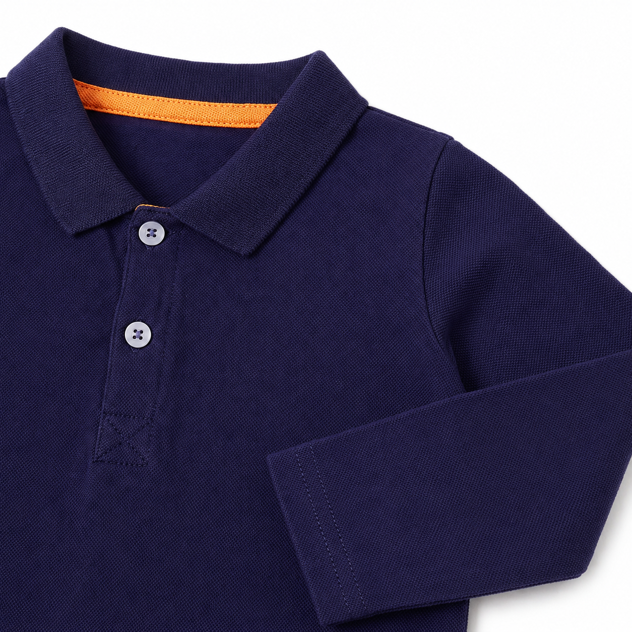 Close-up of the long sleeve and cotton-blend fabric on the navy kids polo.
