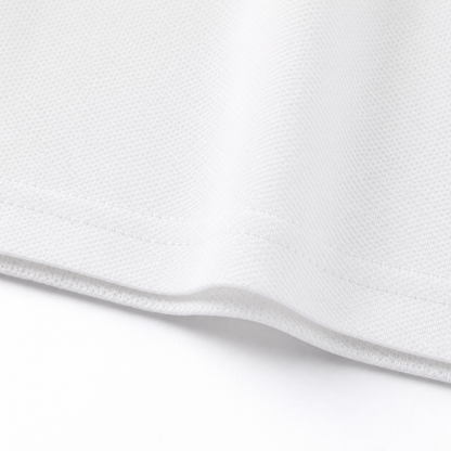 Close-up of the hem and fabric texture on the white kids polo shirt.
