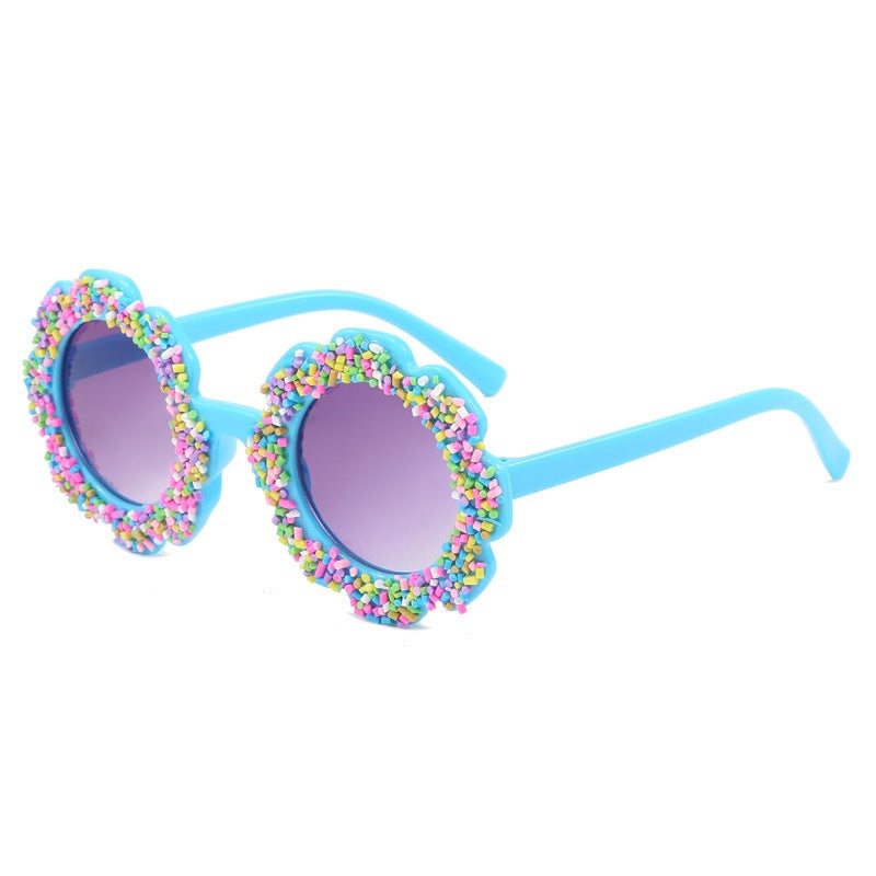 Blue candy bloom kids sunglasses with colorful sprinkle flower frame and UV400 sun protection lenses.
