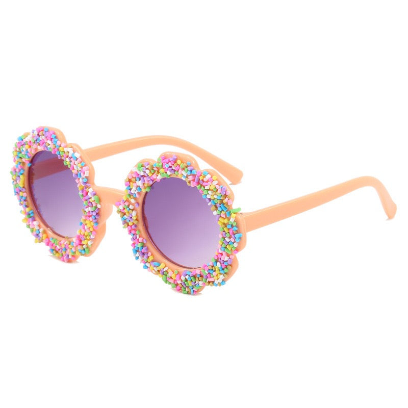 Peach flower kids sunglasses with playful rainbow sprinkle trim and UV400 tinted lenses.