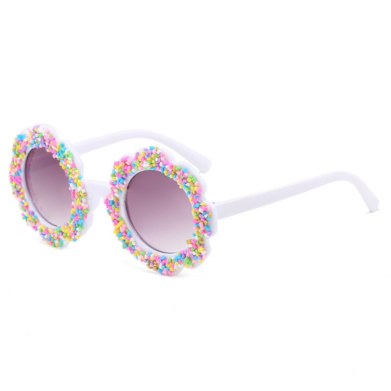 White candy bloom kids sunglasses with flower-shaped frame, colorful sprinkle details, and UV400 lenses.