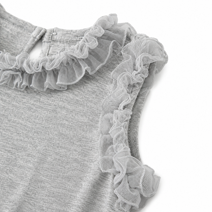 Close-up of the ruffle armhole detail on the girls sleeveless top.