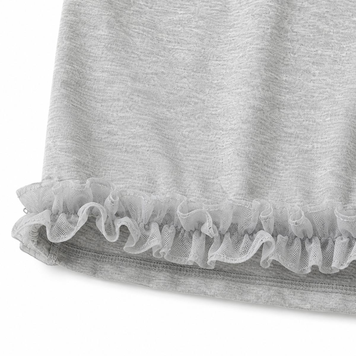 Close-up of the layered ruffle hem detail on the girls sleeveless top.