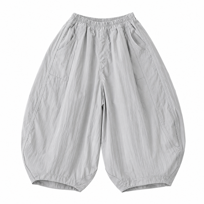 Front flat lay of light gray unisex kids balloon pants with a relaxed curved-leg shape.