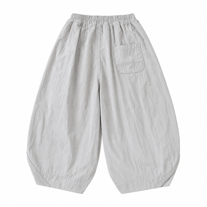 Back flat lay of the light gray kids balloon pants showing the rear patch pocket.