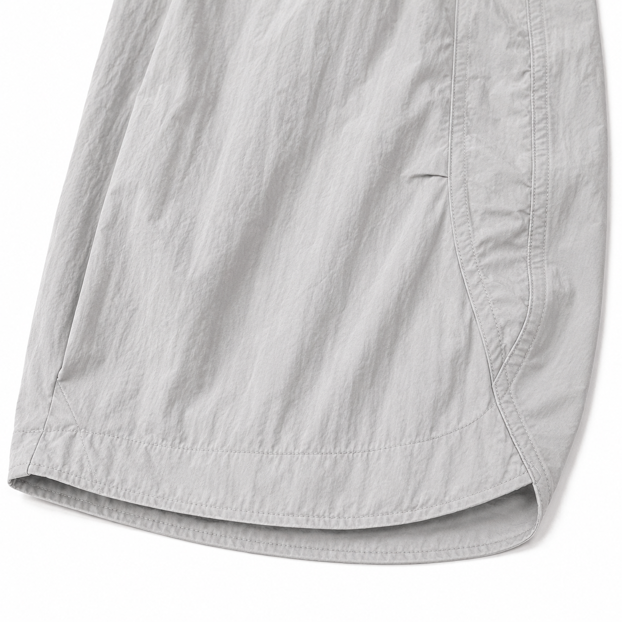 Close-up of the tapered hem and lightweight textured fabric of the light gray kids balloon pants.
