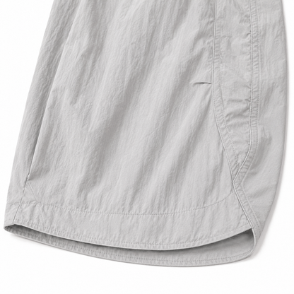 Close-up of the tapered hem and lightweight textured fabric of the light gray kids balloon pants.