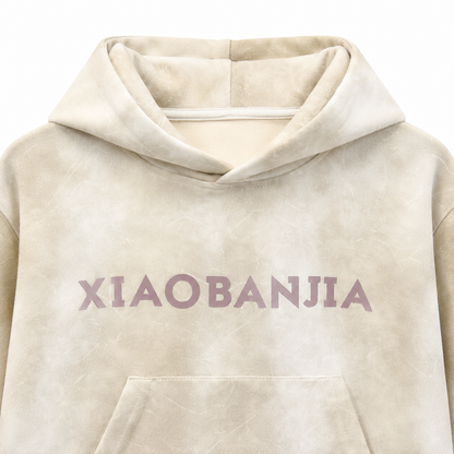 Close-up of the chest graphic detail on the cream kids pullover hoodie.