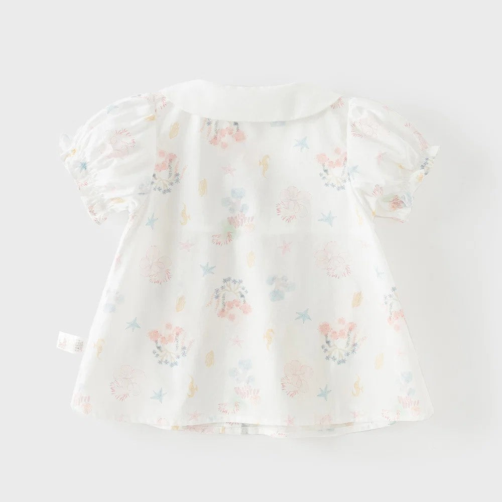 Back view of the white girls cotton blouse with pastel starfish, shells, coral and floral print.