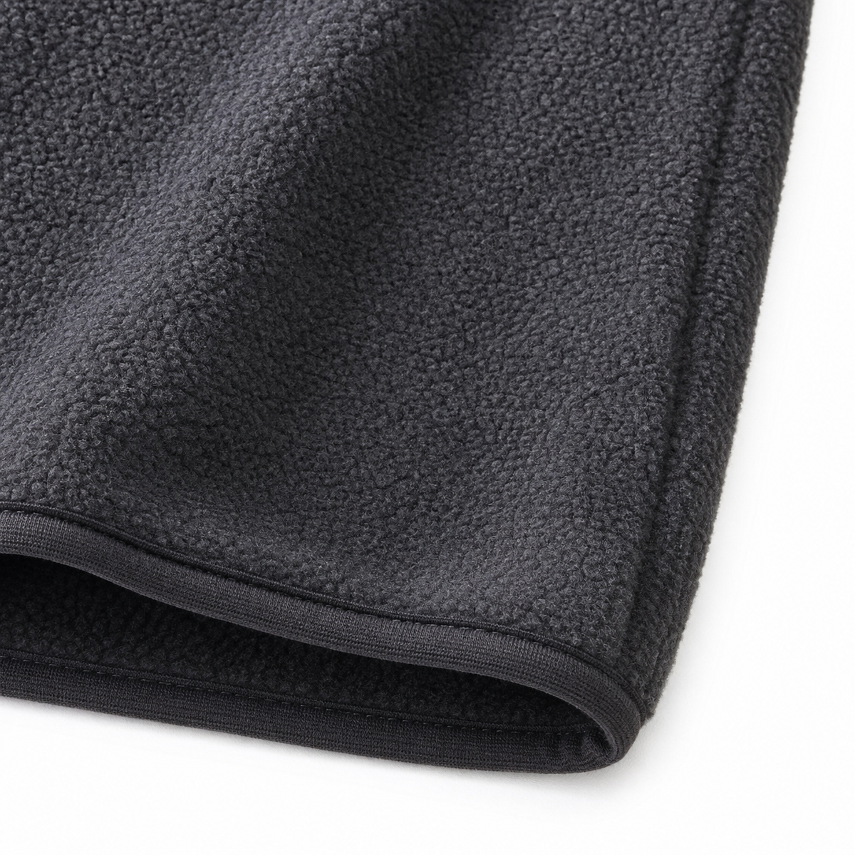 Close-up of the fleece texture and bound hem on the charcoal gray kids vest.