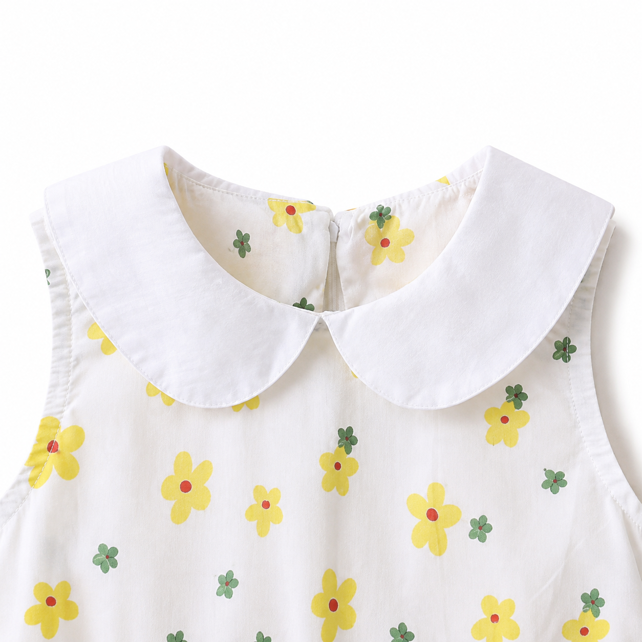 Close-up of the white Peter Pan collar and yellow floral print.