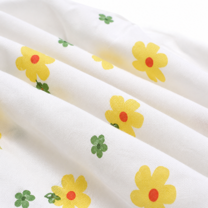 Close-up of the yellow and green floral print on the cotton fabric.