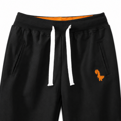 Close-up of the waistband, drawstring, pockets, and knee seam detail on the black kids joggers.